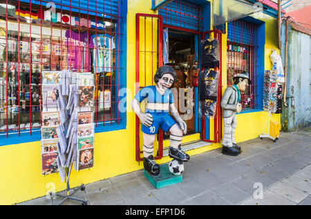 Bildnis des lokalen Fußball-Helden Diego Maradona in den Farben der Boca Juniors außerhalb eines Sport Souvenir shop in La Boca, Buenos Aires, Argentinien Stockfoto