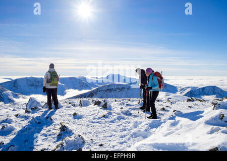 Wanderer Wandern auf Carnedd Dafydd mit Blick nach Süden auf Gipfel oberhalb der niedrigen Cloud aufgrund der Temperatur Inversion im Winter die Sonne. (Eryri) Wales Snowdonia GROSSBRITANNIEN Stockfoto