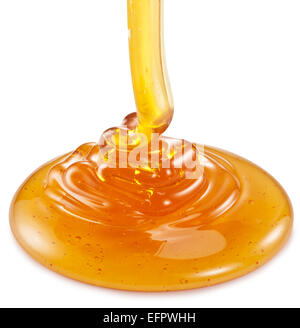 Honig fließt auf dem weißen Hintergrund. Beschneidungspfade. Stockfoto