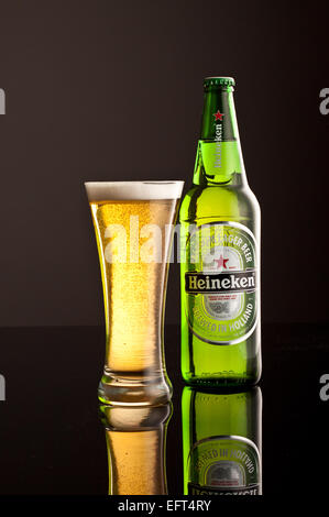 Heineken Lager Flasche mit Glas und schaumige Kopf. Stockfoto