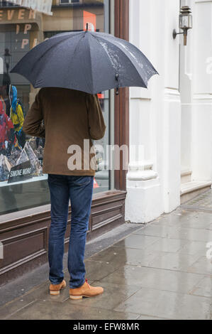 Mann mit Regenschirm, London England Vereinigtes Königreich UK Stockfoto