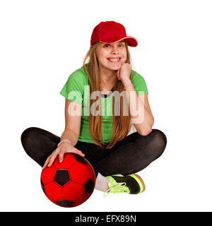 Mädchen sitzen mit Ball auf dem weißen Hintergrund Stockfoto