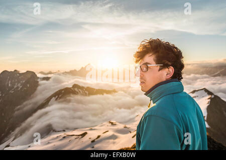 Junge männliche Berg Trekker betrachten über Wolken, Allgäu, Oberstdorf, Bayern, Deutschland Stockfoto