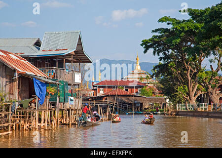 Intha Dorfbewohner in Proas am Seeufer Dorf mit Bambus-Häuser auf Stelzen und buddhistische Tempel, Inle-See, Myanmar / Burma Stockfoto