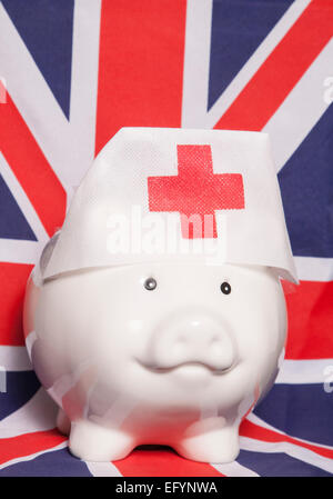 Sparschwein Krankenschwester Hut auf britische Flagge Stockfoto