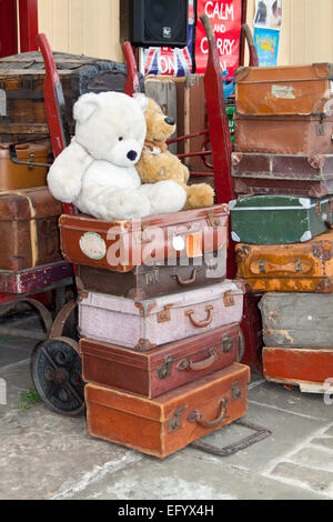 Zwei Teddys auf einen Haufen von Vintage Koffer auf einem Bahnsteig in Bury station während eines der "vierziger Wochenende. Stockfoto