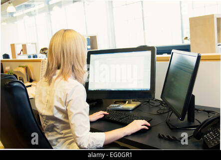 Geschäftsfrau, die Arbeiten am Schreibtisch im Büro Stockfoto