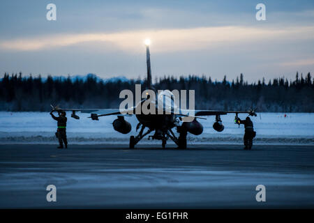 Flieger bereiten Flugzeug f-16 Fighting Falcon 17. Januar 2015, auf Eielson Air Force Base in Alaska, auf der Durchreise nach gemeinsamen Basis Pearl Harbor-Hickam, Hawaii und Andersen Air Force Base, Guam. Mehr als 150 Betreuer halten 18. Aggressor Squadron in der Luft während der Pacific Air Forces Übungen, die dazu bestimmt sind, bereiten Soldaten, Matrosen und Marinesoldaten, zusammen mit Koalitionspartnern im Pacific Theater of Operations für Einsätze bei Bedarf. Die Flieger sind von der 354. Aircraft Maintenance Squadron.  Staff Sgt Joshua Turner Stockfoto