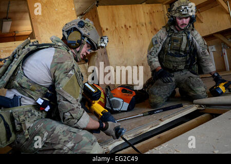 Reißen Sie US Air Force Staff Sgt Jason Lee und Senior Airman Thomas Schalin, 83. Expeditionary Rescue Squadron Pararescuemen Bretter aus einem Stockwerk 26. August 2014, Bagram Airfield, Afghanistan. Während der Mission Proben sie verletzt und ein Gebäude um einen simulierten Unfall retten gelöscht. Lee wird bereitgestellt von der 123. spezielle Taktik-Geschwader in Louisville, KY Trailblazers wird bereitgestellt von Davis-Monthan Air Force Base, Arizona  Staff Sgt Evelyn Chavez Stockfoto