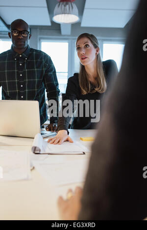 Geschäftsfrau arbeiten an neuen Ideen. Junge Frau zeigt neue Geschäftsvorschlag Kollegen bei einem Treffen im Büro Stockfoto