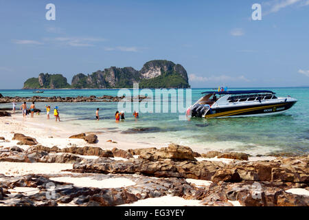 Touristen und ihr Boot in den Gewässern des Bamboo Island in der Nähe von Koh Phi Phi in der Andamanensee an Thailands Westküste. Stockfoto