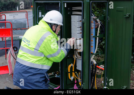 BT-Service-Ingenieur arbeitet an einer Breitband-Internet-Faser Kabinett auf der Straße Stockfoto