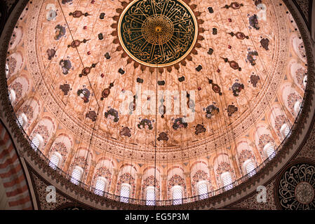 ISTANBUL, Türkei / Türkiye — verzierte dekorative Gemälde und Kalligrafie zieren die Kuppeln der Suleymaniye-Moschee im Inneren. Die komplizierten Designs kombinieren geometrische Muster, Blumenmotive und islamische Kalligraphie im klassischen osmanischen Stil. Diese dekorativen Elemente, die 1558 fertiggestellt wurden, zeigen die künstlerische Raffinesse, die während der Herrschaft Sultans erreicht wurde. Stockfoto