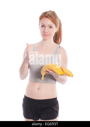 Sportliche Mädchen mit Bananen in der Hand auf weißem Hintergrund. Stockfoto