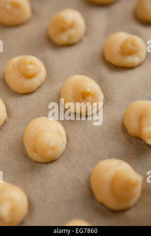 Hausgemachte Chouquette auf ein Backblech legen, bevor Sie in den Ofen gehen. Stockfoto