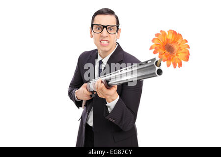 Wütend Geschäftsmann Dreharbeiten Blumen aus einem Gewehr isoliert auf weißem Hintergrund Stockfoto