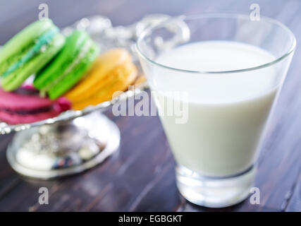 Milch im Glas und Farbe Makronen Stockfoto