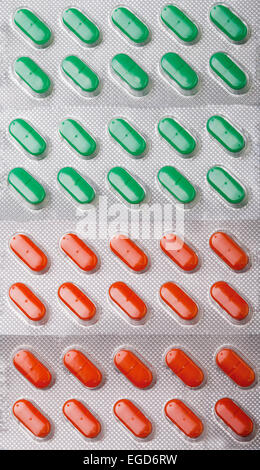 Vertikale Hintergrund von Grün und orange Pillen in vier Blister Stockfoto