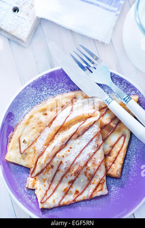 Pfannkuchen auf Teller und auf einem Tisch Stockfoto