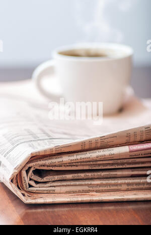 Zeitung und Kaffee auf Holztisch Stockfoto