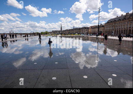 Kinder spielen im Wasser im Miroir d ' Eau in Place De La Bourse. Stockfoto