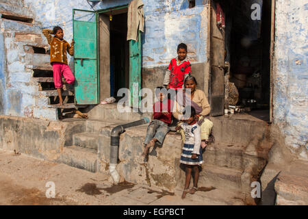 eine indische Familie sitzt außerhalb der eigenen Wohnung in Jodhpur, Indien Stockfoto