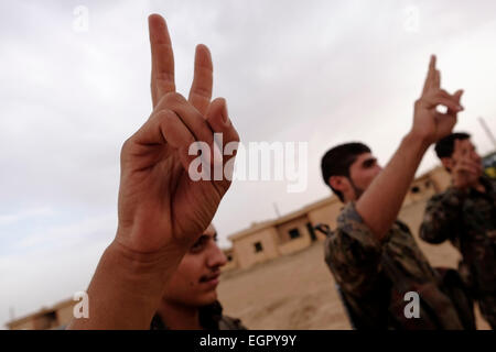 Kurdische Kämpfer der Volksschutzeinheiten YPG markieren die Siegeszeichen bei einer Abschlussfeier in einem Trainingslager In Al Hasaka oder Hassakeh Distrikt im Norden Syriens Stockfoto