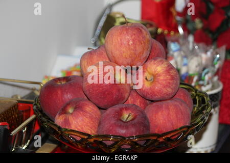 Dekoratives Glasschüssel voller rötlich gefärbten Äpfel Stockfoto