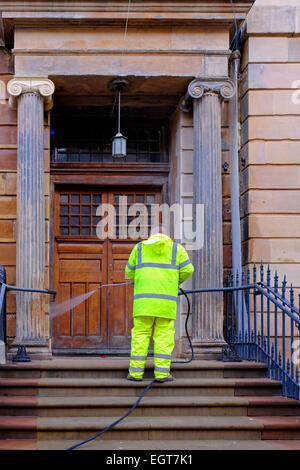 Arbeiter mit hohem Druck Unterlegscheibe zum Clan der Blüte farbigen Sandsteinfassade eines Gebäudes, Bath Street, Glasgow, Schottland Stockfoto