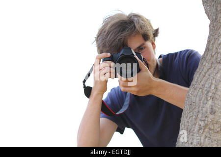 Paparazzi ein Foto versteckt auf weiß isoliert auf weißem Hintergrund Stockfoto