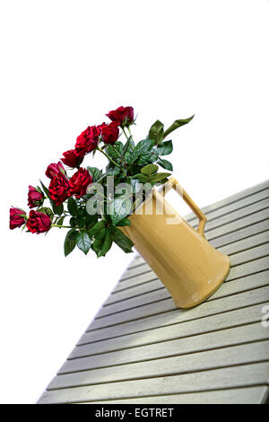 Bouquet von schöne rote Rosen in einer Vase am grünen Tisch Stockfoto