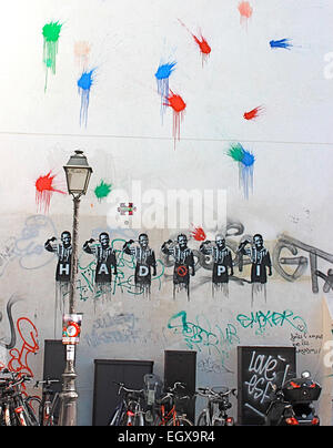 Mehrere Arten von Graffiti auf Mauerbau in Paris, Frankreich. Geklonte männlichen Bilder tragen Buchstaben und Pistole an den Kopf. Stockfoto