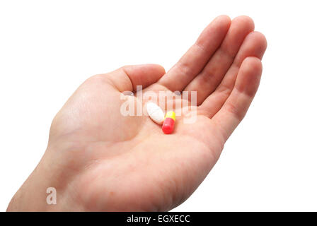 Menschliche Palme und zwei Pillen. Isoliertes Objekt. Stockfoto