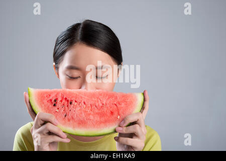 Junge Frau, die Wassermelone essen Stockfoto