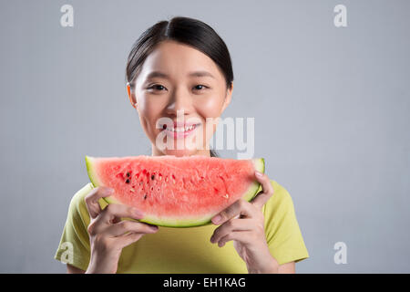 Junge Frau, die Wassermelone essen Stockfoto