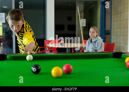 Bei einem Jugendprojekt in Rogerfield und Easterhouse; Unter 12 Jahren spielen auf dem Billardtisch Stockfoto