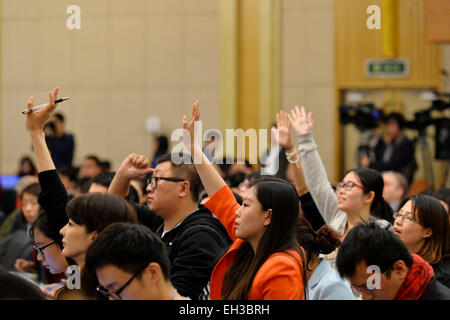 Peking, China. 6. März 2015. Journalisten Raise Hände während einer Pressekonferenz Fragen, für die dritte Sitzung des Chinas 12. nationalen Volksarmee Kongress (NPC) auf das Geschäftsjahr und Steuer, in Peking, Hauptstadt von China, 6. März 2015 zu reformieren. © Li Xiang/Xinhua/Alamy Live-Nachrichten Stockfoto