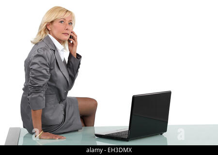 Senior Geschäftsfrau auf ihrem Schreibtisch Stockfoto