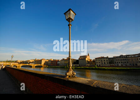 Alte verzierte Laterne am Lungarno Degli Acciaiuoli Straße neben Arno Fluss (Ponte Santa Trinita-Brücke), Florenz, Italien Stockfoto