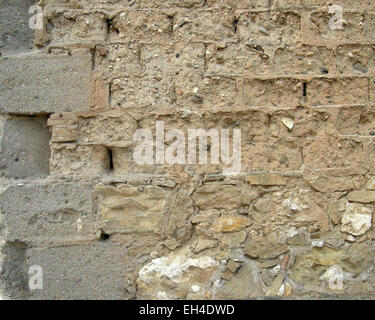 Rand der Mauer aus Lehmziegeln mit einigen kleinen Steinen und Stroh und Beton Ziegel Stockfoto