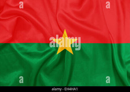 Burkina Faso - winken Nationalflagge auf Seide Textur Stockfoto