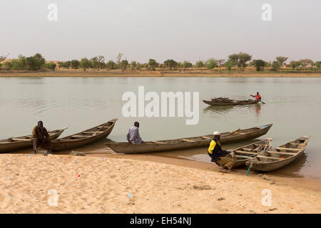 In der Nähe von NIAMEY, NIGER, 15. Mai 2012: A Fährmann trägt Brennholz flussabwärts am Fluss Niger. Stockfoto