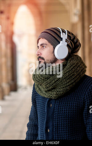 ein junger Mann hört Musik in einem städtischen Bild des modernen Lebensstils Instagram getönt Stockfoto