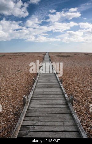 Holzsteg, der führt über den Kiesstrand bei Dungeness, Kent, England, UK Stockfoto