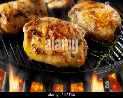 Hähnchenschenkel Kochen in einer Pfanne Pfanne über Flammen Stockfoto