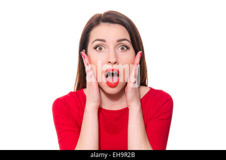 Adorable woman with red lipstick standing in awe looking at camera with mouth and eyes open wide surprised isolated on white bac Stockfoto