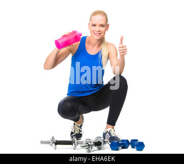 Frau trägt Fitnesskleidung und trinken nach dem Training mit Gewichten Stockfoto