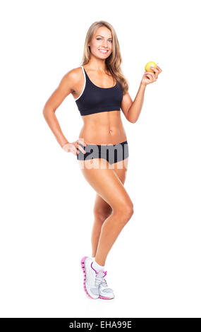 Lächelnde Mädchen hält grünen Apfel in der hand. Fitness-Frau isoliert auf weißem Hintergrund Stockfoto
