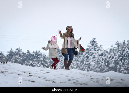 Teheran, Iran. 10. März 2015. Eine Frau und ihre Tochter spielen mit Schnee in Nord-Teheran, der Hauptstadt des Iran, am 10. März 2015. Der erste Schnee im Jahr 2015 getroffen Teheran am Dienstag. © Ahmad Halabisaz/Xinhua/Alamy Live-Nachrichten Stockfoto