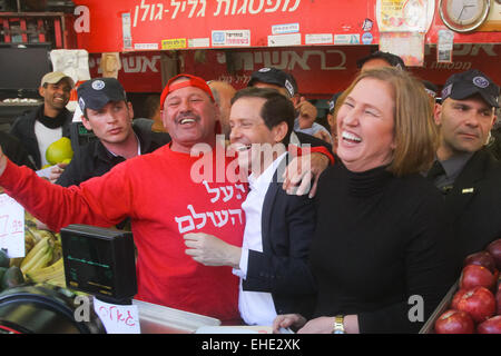 (150312)--JERUSALEM, 12. März 2015 (Xinhua)--Israels zionistische Gewerkschaftsführer Isaac Herzog (3. R) und Tzipi Livni (2. R), sind bei einem Kampagne Stopp an einem Obst und Gemüse Markt in Tel Aviv, Israel am 12. März 2015 mit einem Anbieter gesehen. Israelische politischen Parteien verstärken ihre Anstrengungen, unentschlossene Wähler zu beeinflussen, wie der Countdown für die 17 März Parlamentswahlen begonnen hat. Unterstützer der regierenden Likud-Partei haben, eine Massendemonstration in zentralen Tel Aviv Sonntagabend zu inszenieren, um Unterstützung zu generieren nach einer massiven Widerstand-Kundgebung am vergangenen Wochenende in der Stadt fordert die r geplant Stockfoto